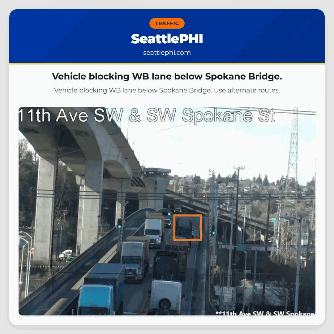 Vehicle blocking WB lane below Spokane Bridge.